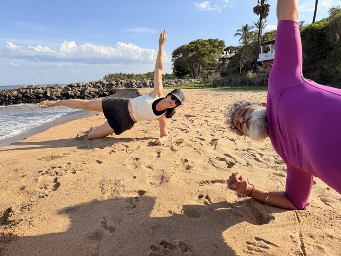 Close-up of a side-plank reach with Rotem spotting in the foreground